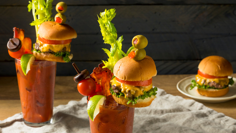 Bloody Marys with mini burgers and vegetable garnishes