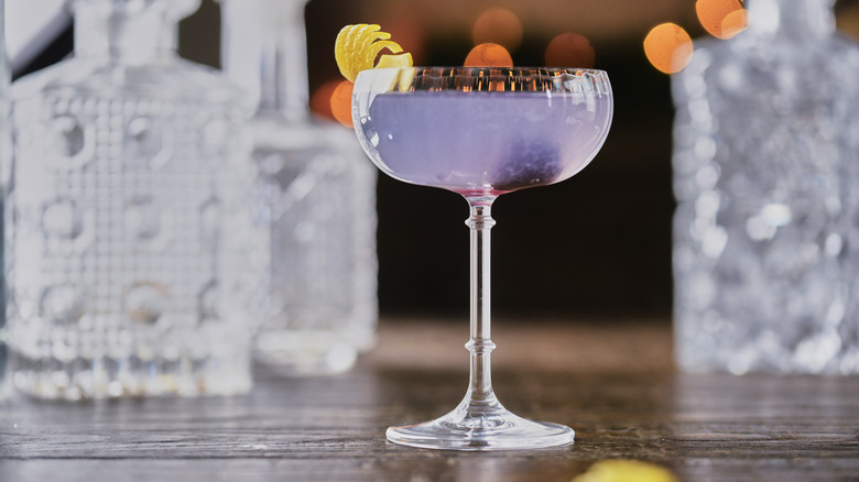 purple cocktail in stemmed glass
