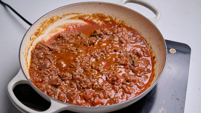 tomato sauce and spices simmering in skillet