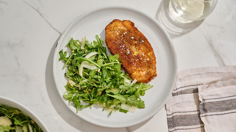 chicken milanese on a plate on a table