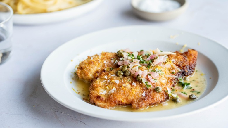 chicken cutlets on plate with capers