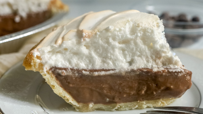 slice of chocolate meringue pie on a white plate