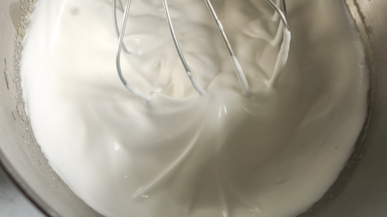 whipped egg whites in a mixing bowl