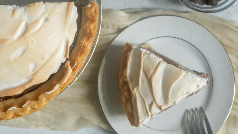 slice of chocolate meringue pie on a white plate