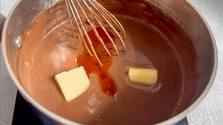 butter chunks and liquid chocolate mixture in a metal pot