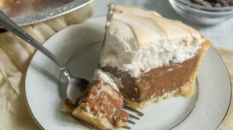 slice of chocolate meringue pie on a white plate