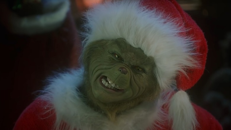 The Grinch wearing a Santa suit