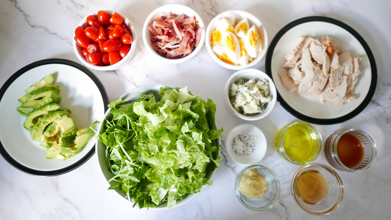 Cobb salad ingredients in bowls