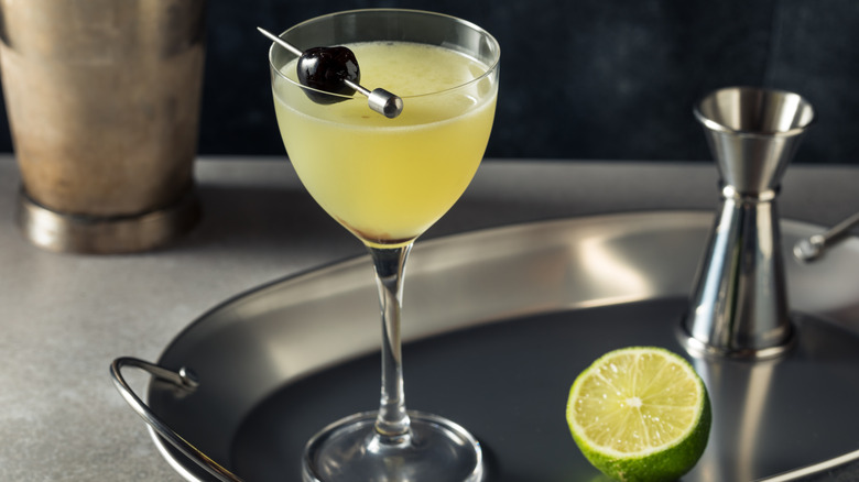Last Word cocktail on tray with half a lime