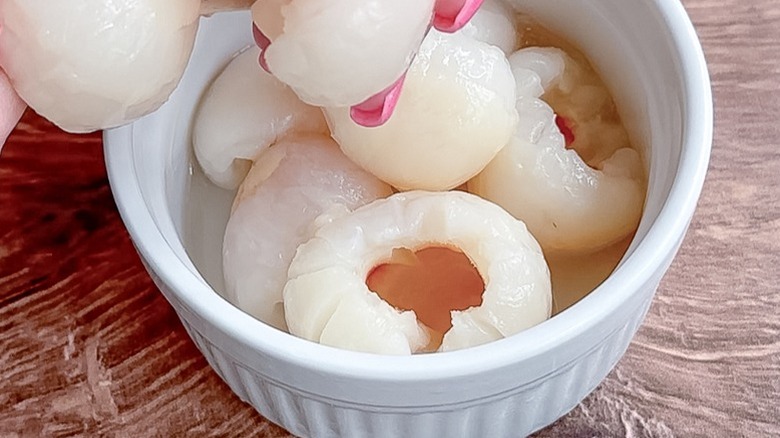 canned lychees with pink fingernails