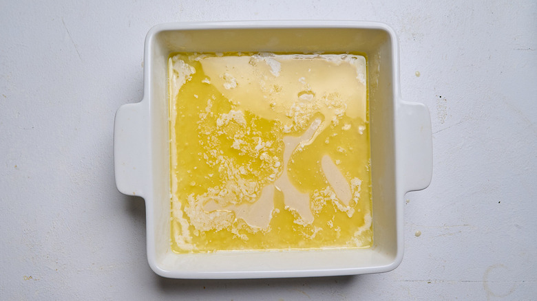 Batter poured into baking dish with butter