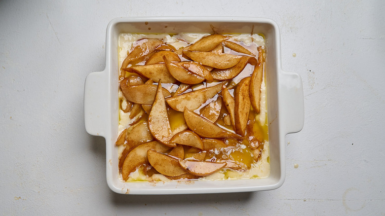 pears added to baking dish on top of batter