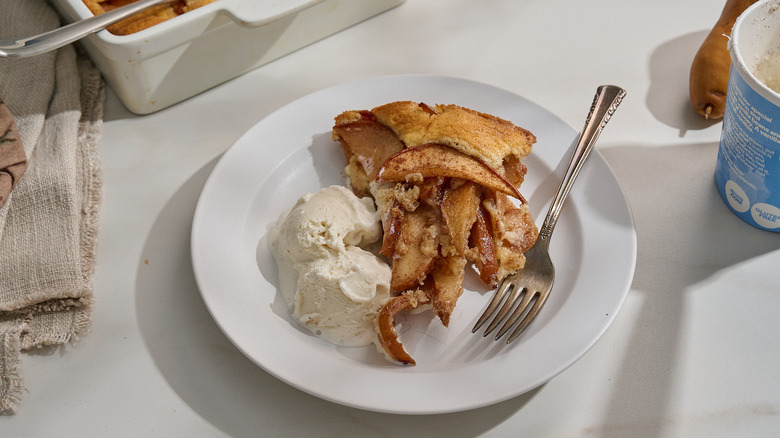 slice of cobbler on a plate with ice cream
