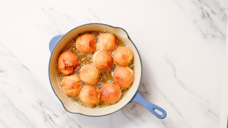 Fried donuts in pot