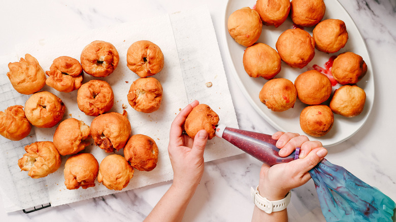 Piping jam into sufganiyot