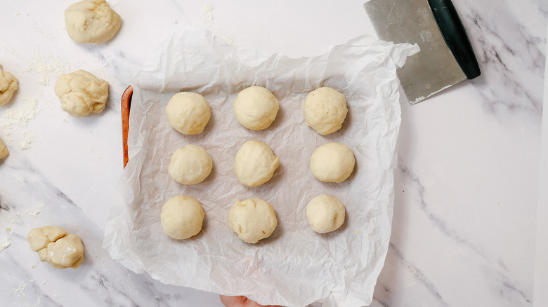 Dough cut into balls and bench scraper