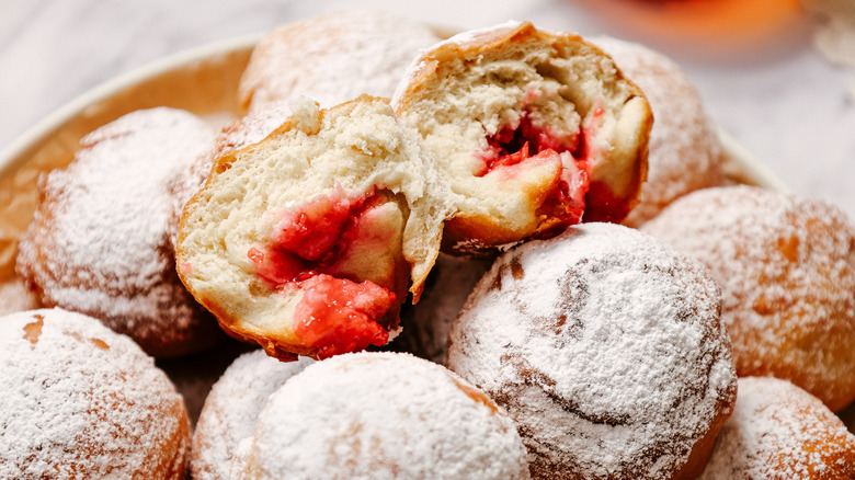 Close up on sufganiyot with one cut in half