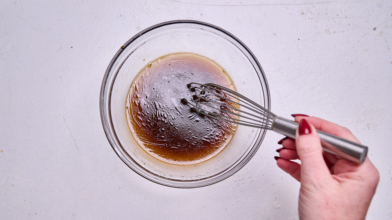 whisking sauce together in a bowl
