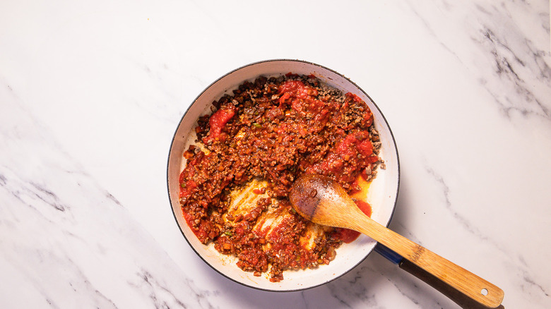 Meat ragu in tomato sauce in pan
