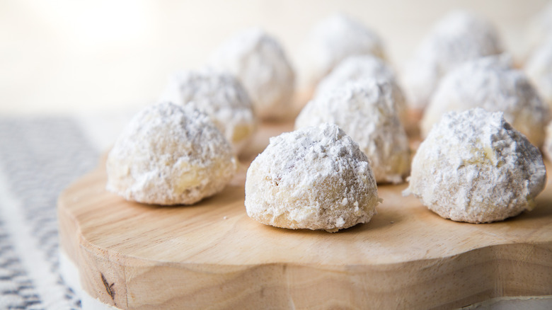 snowball cookies on cutting board