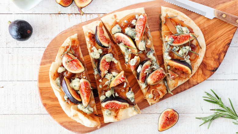 Flatbread with figs and goat cheese on cutting board