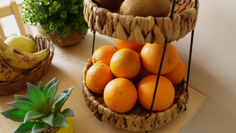 Tiered baskets holding fruit on a kitchen countertop