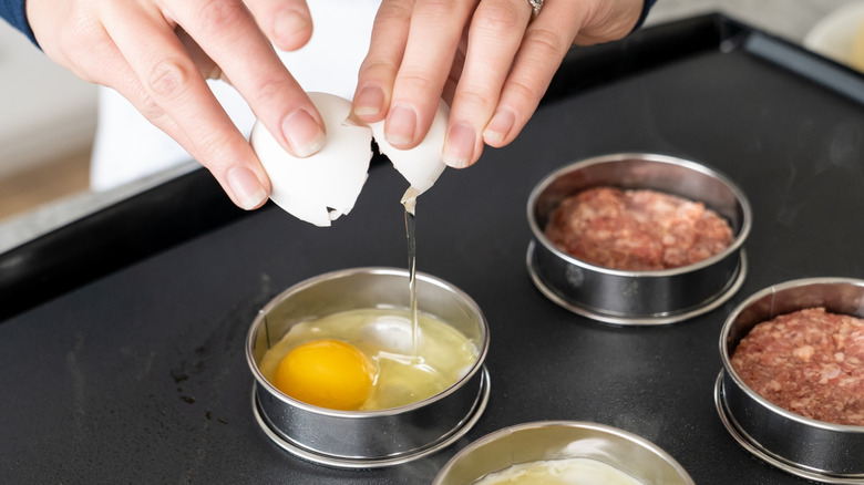 cooking eggs and meat on griddle