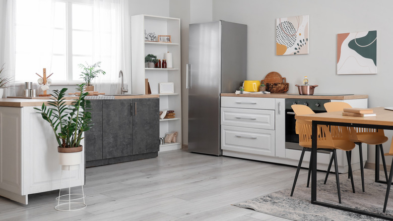 a kitchen with cabinets, stove and refrigerator