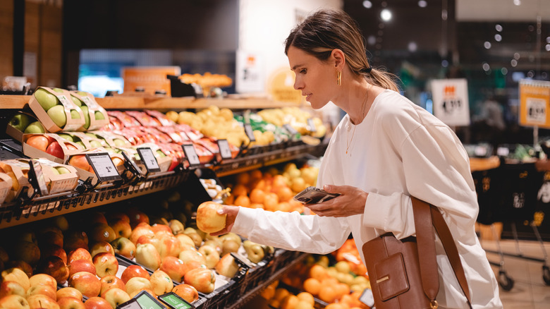Woman shopping for produce in a grocery store