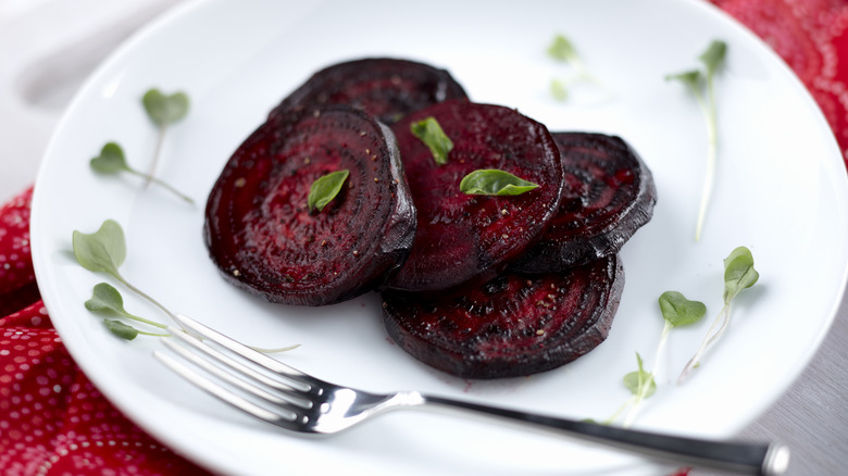roasted beets on white plate with fork