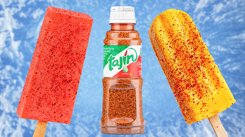 Bottle of Tajín in between two red and yellow popsicles