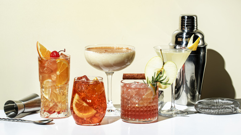 An assortment of cocktails with bar tools