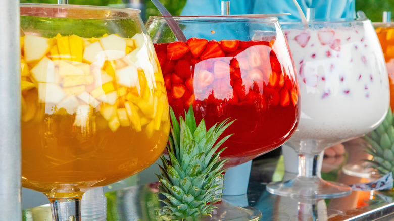 different tropical punches in large bowls