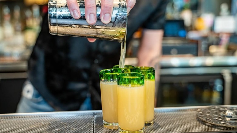 Bartender pouring green tea shots