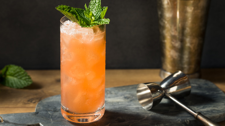 Zombie cocktail in a tall glass, garnished with sprigs of mint