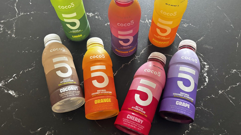 Various Coco5 coconut water drink bottles on countertop