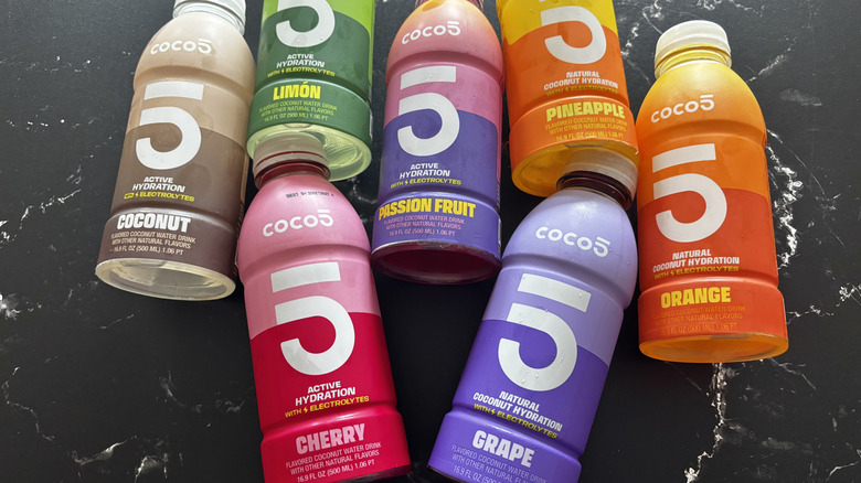 Various Coco5 coconut water drink bottles on countertop