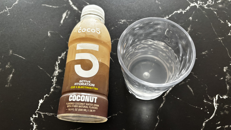 Coconut Coco5 bottle next to liquid in cup