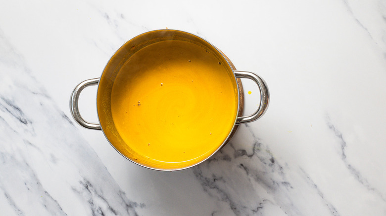 Pot with yellow liquid.