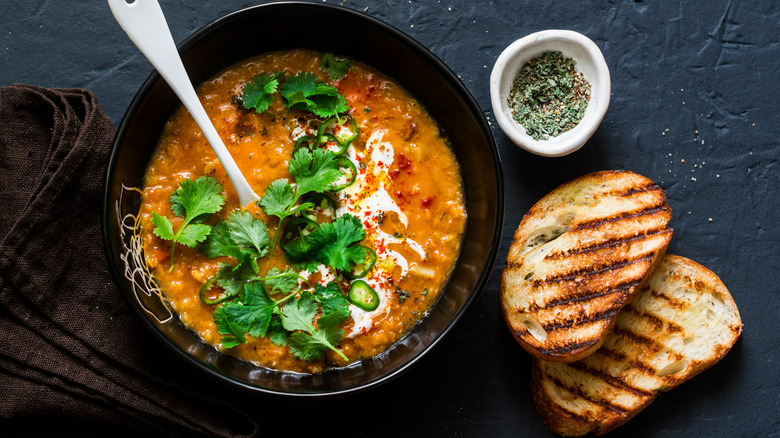 bowl of lentils with coconut milk and grilled bread