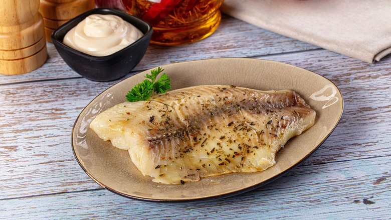 Steamed tilapia with spices and a ramekin of mayo