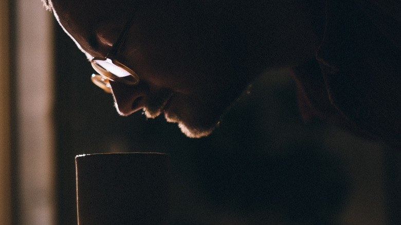 Person smelling coffee