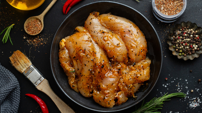 Chicken breast pieces being brined in coffee and spices