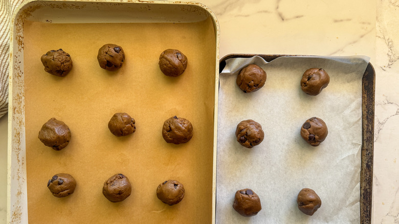 cookie dough in balls on sheets