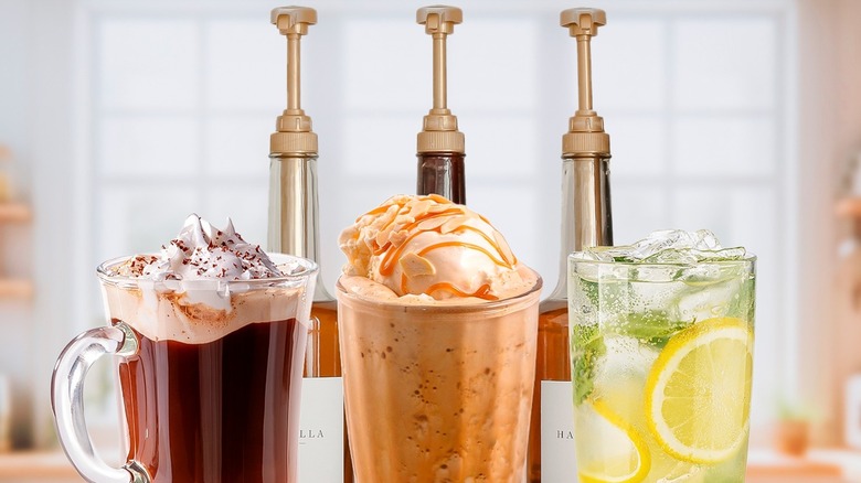 Three coffee syrup bottles behind three different beverages