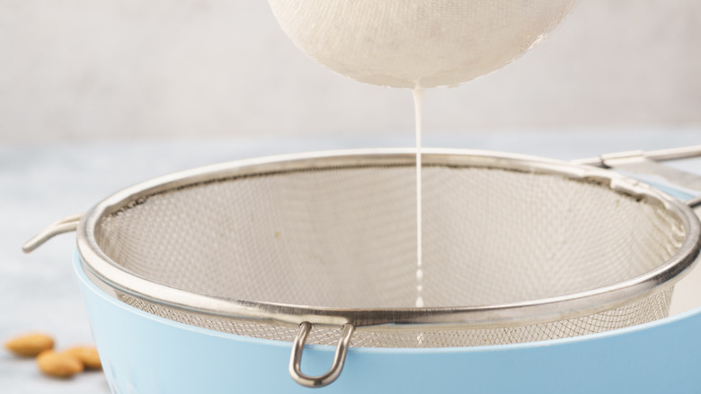 nut milk in fine mesh sieve