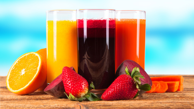 Fresh juices on wooden table