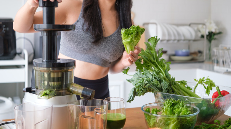 Woman making cold press juice