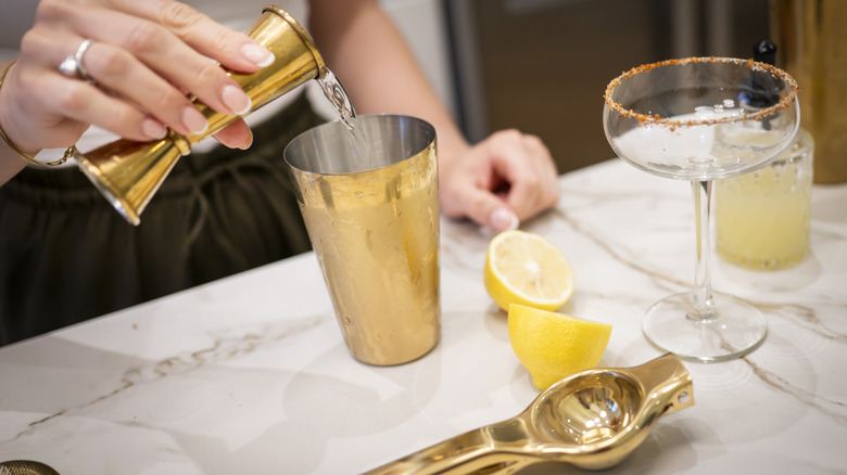 person making cocktail with tool set