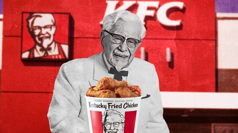 Colonel Sanders and chicken bucket in front of KFC